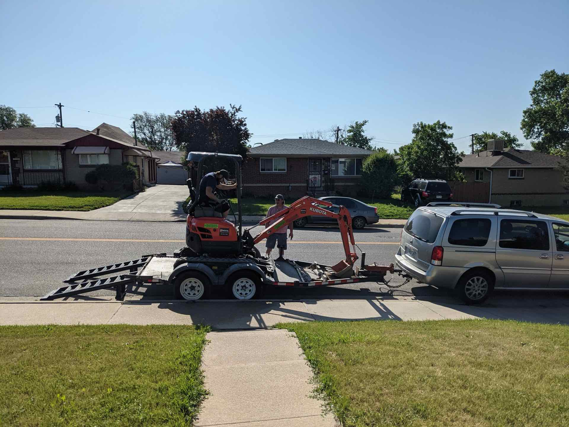 The rented excavator in the yard